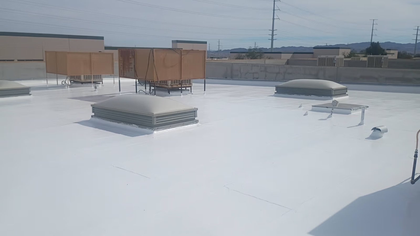 Finished white silicone elastomeric coating on a commercial flat roof in Las Vegas